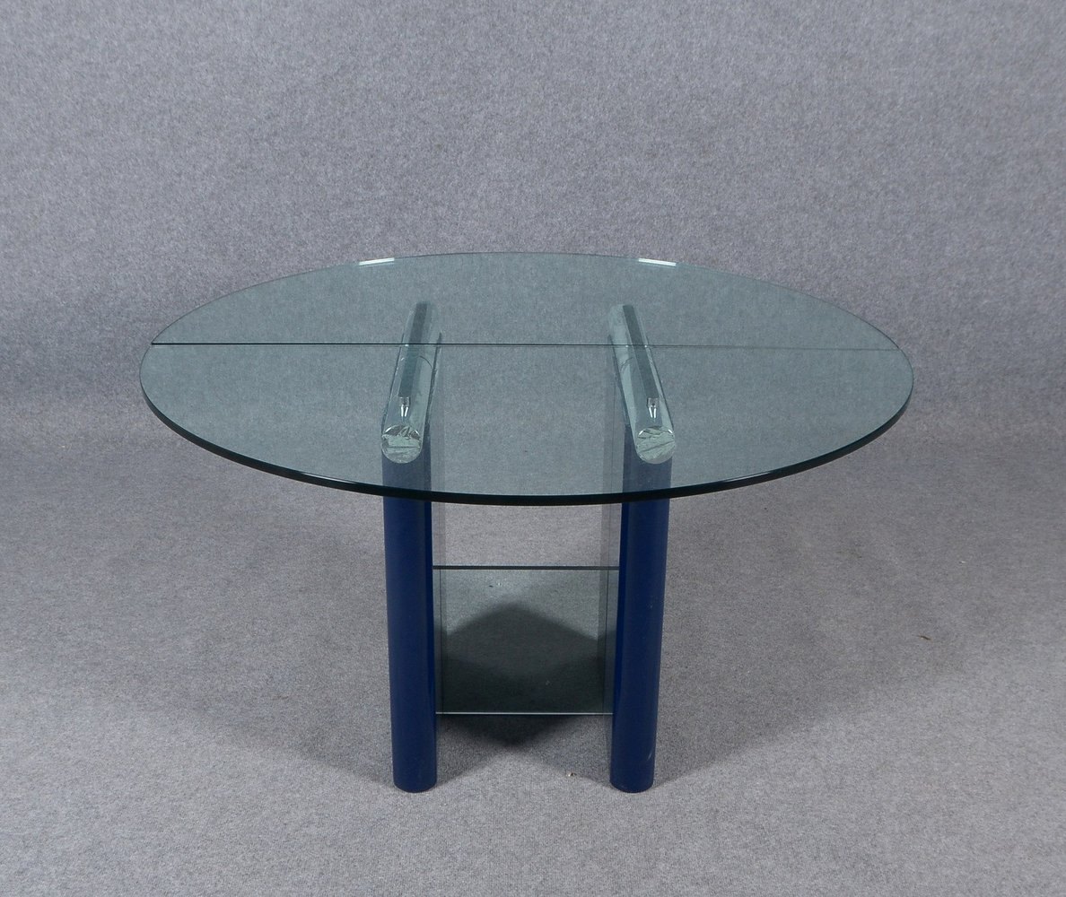 Esstisch, runde Form, T-förm. Gestell/teils in blauem Klavierlack, mit 2x Glasplatten