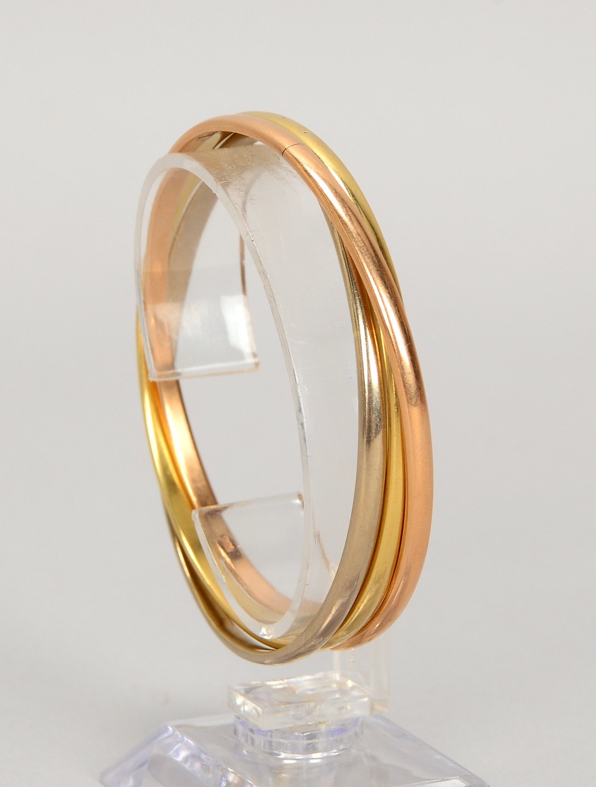 Armreif, 585 Gold/tricolor (gest.), in der Art eines 'Trinity-Rings'; Ø 63 mm, Gew. 45,50 g