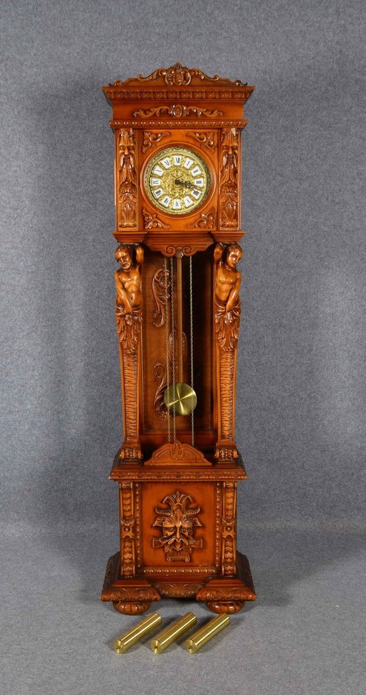 Standuhr, Holzgeh. mit figürl. Schnitzereien, Pendel und 2x Gew. anbei; Höhe 202 cm