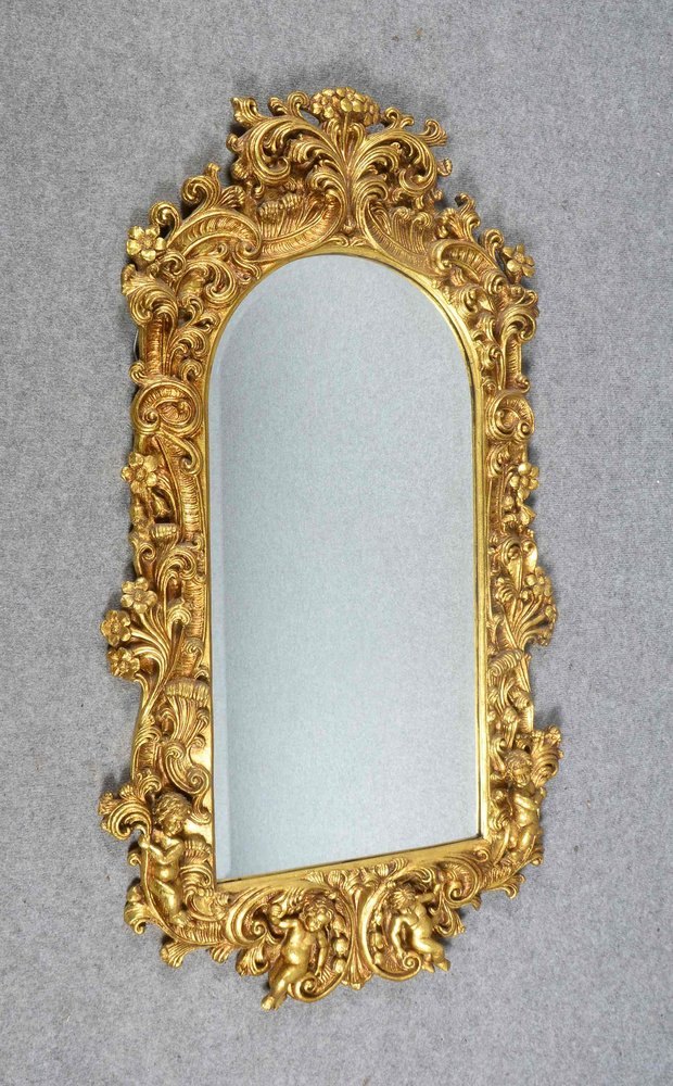 Wandspiegel, floral geschn. Holzrahmen/vergoldet, mit fac. Glas; Maße 118 x 67 cm
