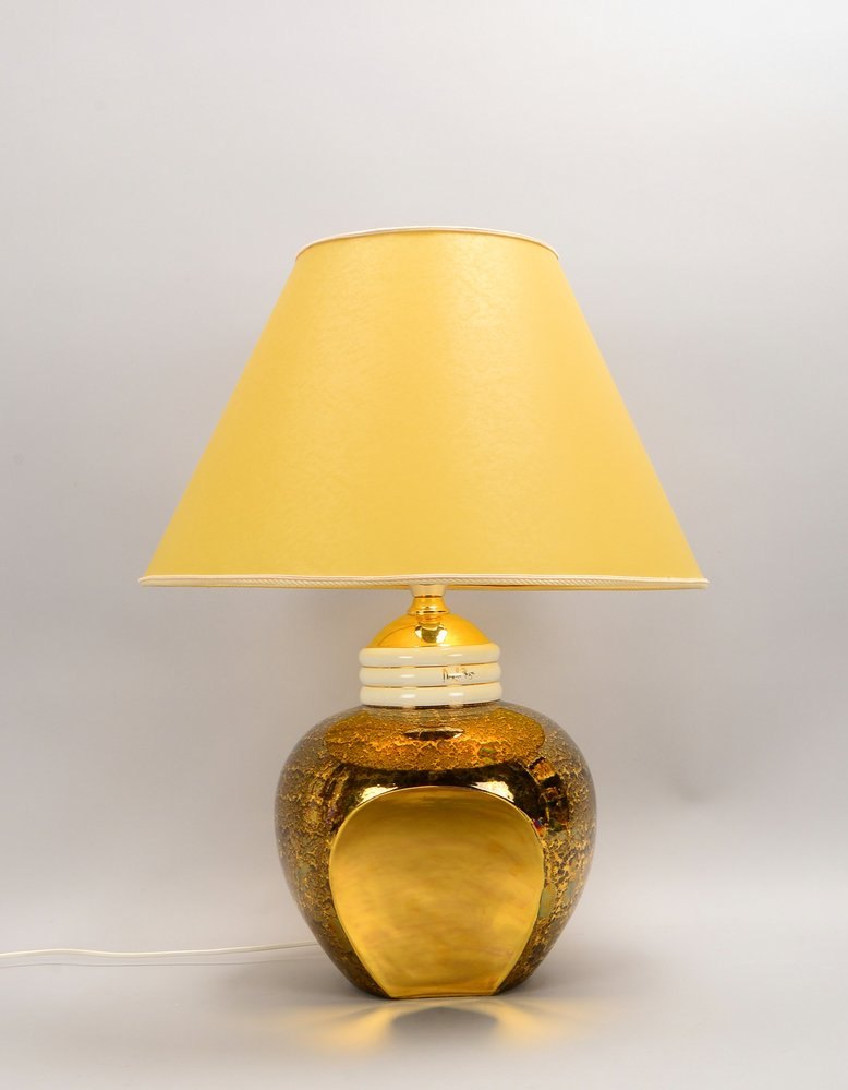 Angela Rigoni, Porz.-Tischlampe, goldf./irisierend gefasst, champagnerf. Schirm, sign.