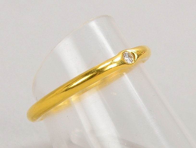 Niessing-Ring, 950 GG (gest.), besetzt mit kl. Brillant von ca. 0,03 ct; RG 54, Gew. 3,20 g