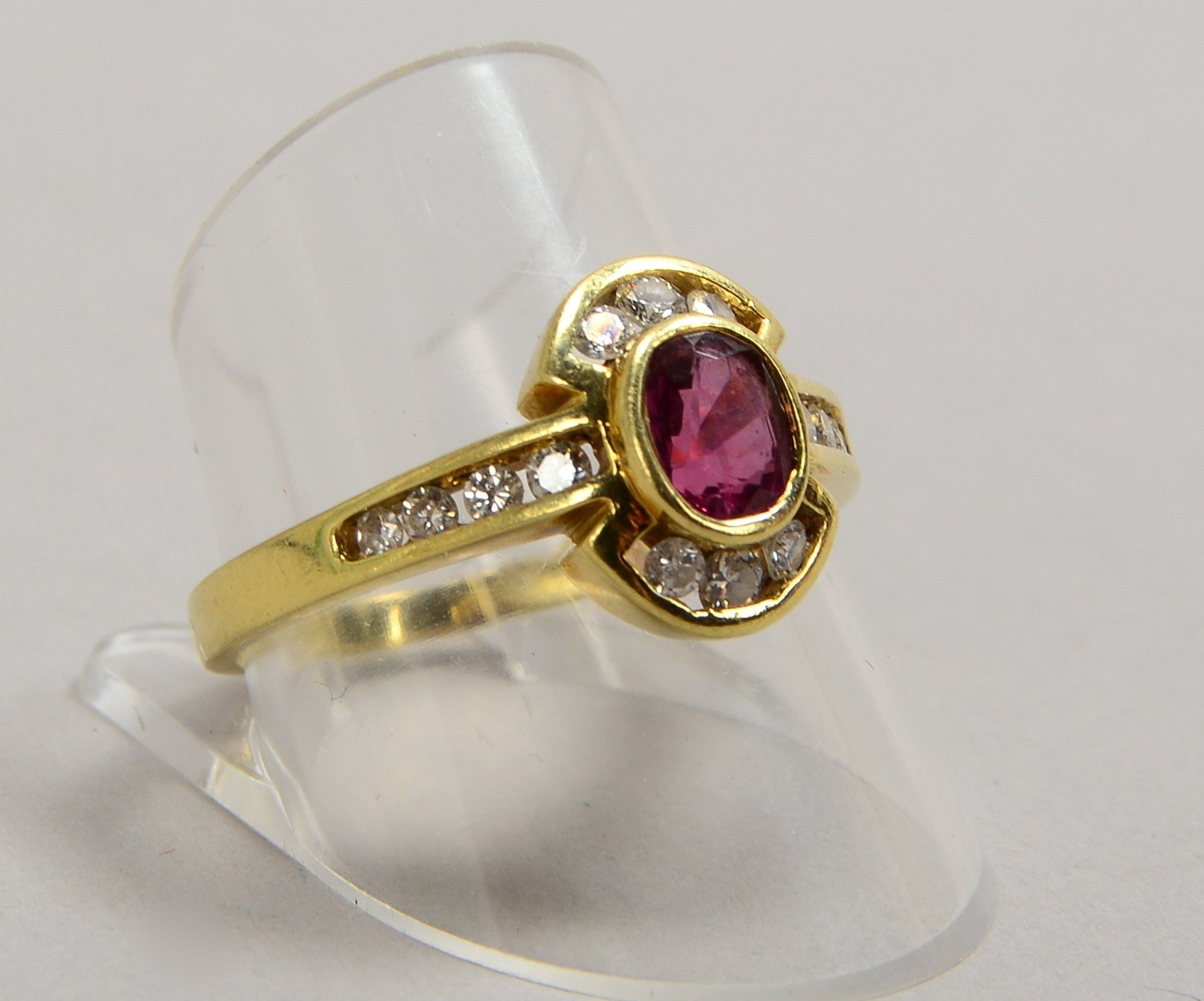 Ring, 585 GG (gest.), mit einzelnem Rubin und 14x kl. Diamanten; RG 61, Gew. 4,10 g