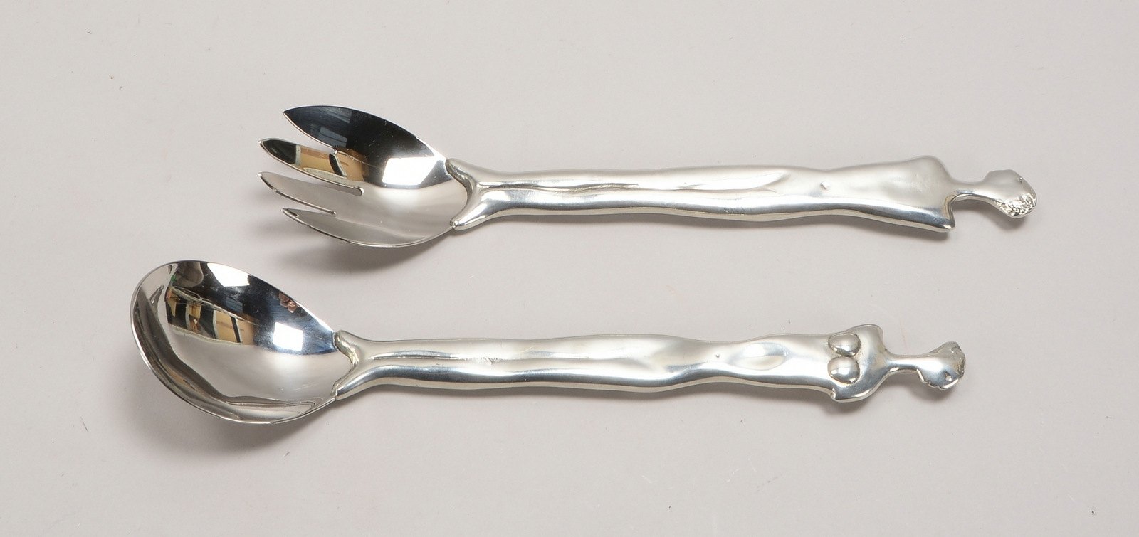 2-tlg. Salatbesteck, Edelstahl-Laffe/Zinken, figürl. Zinnstiel, Entw. Carrol Boyes