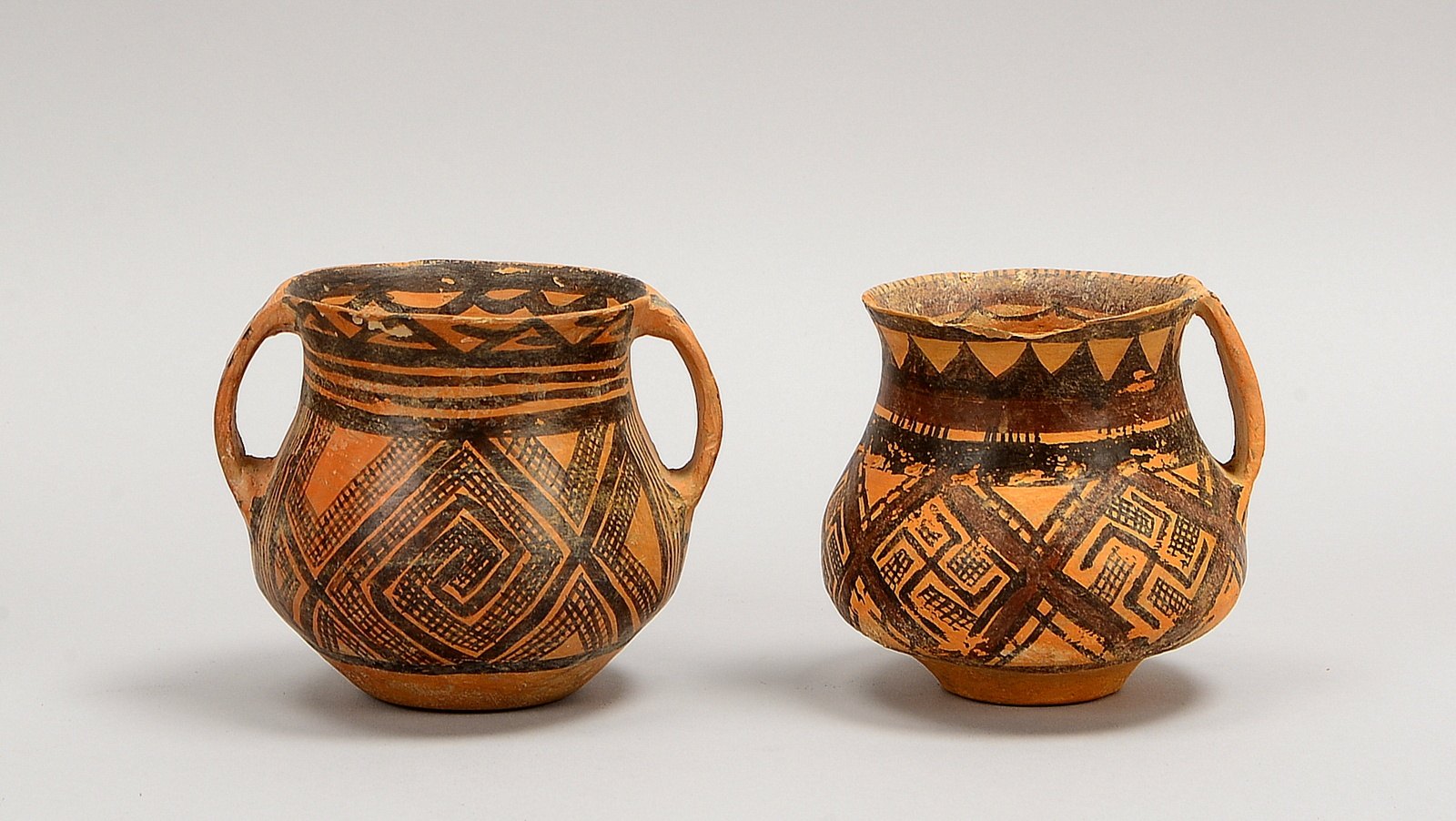 Paar Tongefäße (China), mit ornamentaler Schwarzmalerei; Höhe jeweils 10,5 cm