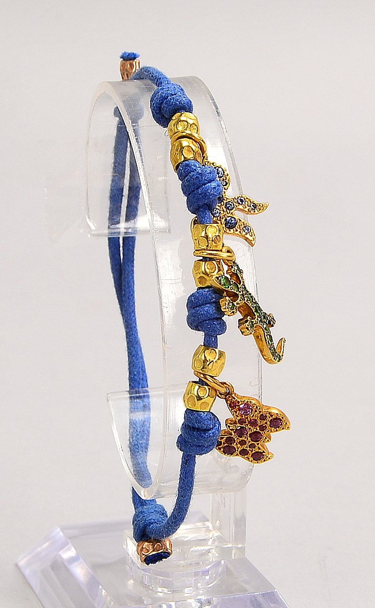 DoDo, 'Prêt-à-Dodo', 3x Charms, 750 WG (gest.), jeweils mit Steinbes., an Kordelarmb.