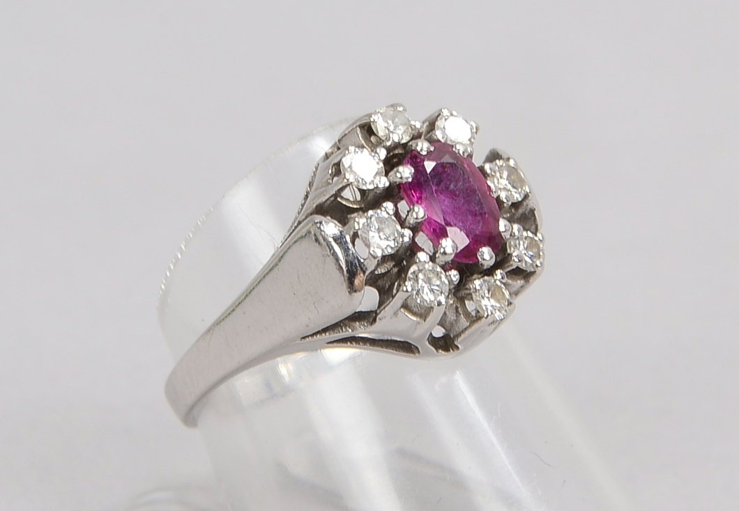 Ring, 585 WG (gestempelt), besetzt mit einzelnem Rubin, Stein mit einer Entourage aus Diamanten; RG