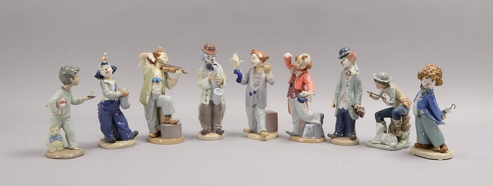 Marco Giner/Spanien, 9 Porz.-Figuren (in Lladro-Art), davon 7x Clowns - versch. Darst.