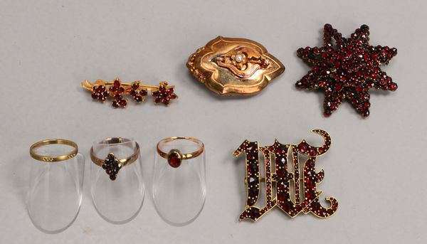 Kleines Granatschmuck-Konvolut: 4x Broschen, Metall, und 3x Ringe, 333 Gold