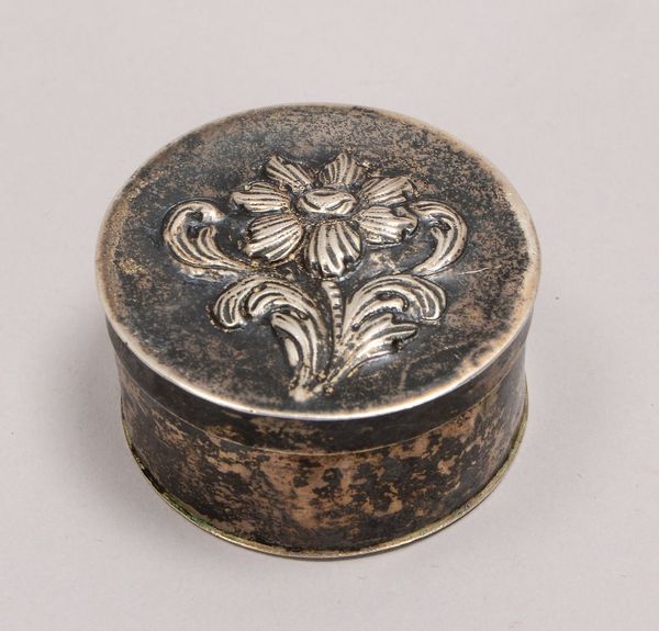 Kl. Dose, Silber (punz./Tremolierstrich), Deckel mit relief. Blütenmotiv; Gew. 17,5 g