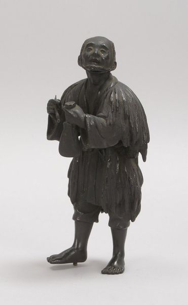 Bronzeskulptur, 'Mann mit Glocke', als Steckfigur, mit dunkler Patina; Höhe 16 cm