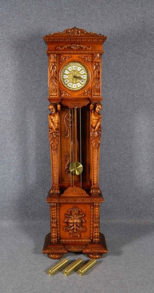 Standuhr, Holzgeh. mit figürl. Schnitzereien, Pendel und 2x Gew. anbei; Höhe 202 cm