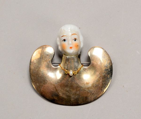 Brosche, 925 Sterlingsilber, mit polychr. Porz.-Einsatz ('Kopf') und kl. Holzkette/mit Perle