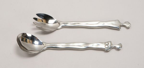 2-tlg. Salatbesteck, Edelstahl-Laffe/Zinken, figürl. Zinnstiel, Entw. Carrol Boyes