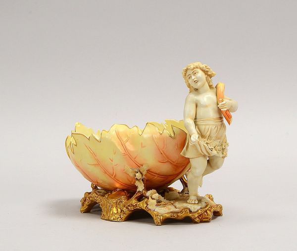 Porzellanfigur, 'Putto mit Schale', rosafarben staffiert, mit 'Blüten'/'Blattranken'