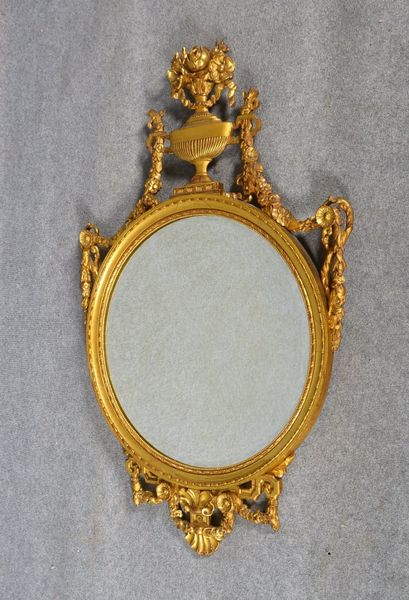 Empire-Wandspiegel, rund, fac. Spiegelglas, holzgeschn./vergoldet; Höhe ca. 120 cm